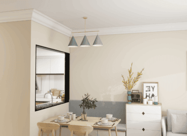 Simple modern dining area with pastel pendant lights and decorative interior mouldings.
