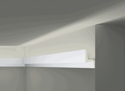 Coving moulding installed along the ceiling in a contemporary room.