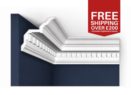 Decorative white dentil cornice moulding in a room with dark blue walls, showcasing traditional UK c.