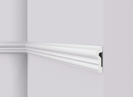 Coving moulding with decorative profile for interior wall finishing.