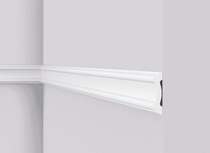 Decorative white coving moulding on a wall corner.