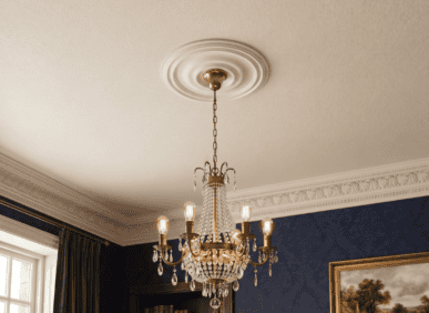 Chandelier with crystal details hanging from a decorative ceiling medallion in a classic interior.