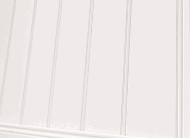 Decorative dado wall paneling with vertical grooves in a traditional UK interior.