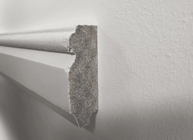 Decorative wall moulding profile for interior walls, showing detailed edge and surface texture.