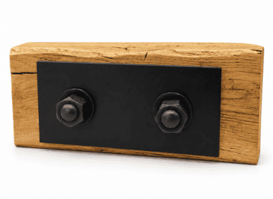 Decorative wooden wall mount with black metal bolts, suitable for interior design in UK homes.